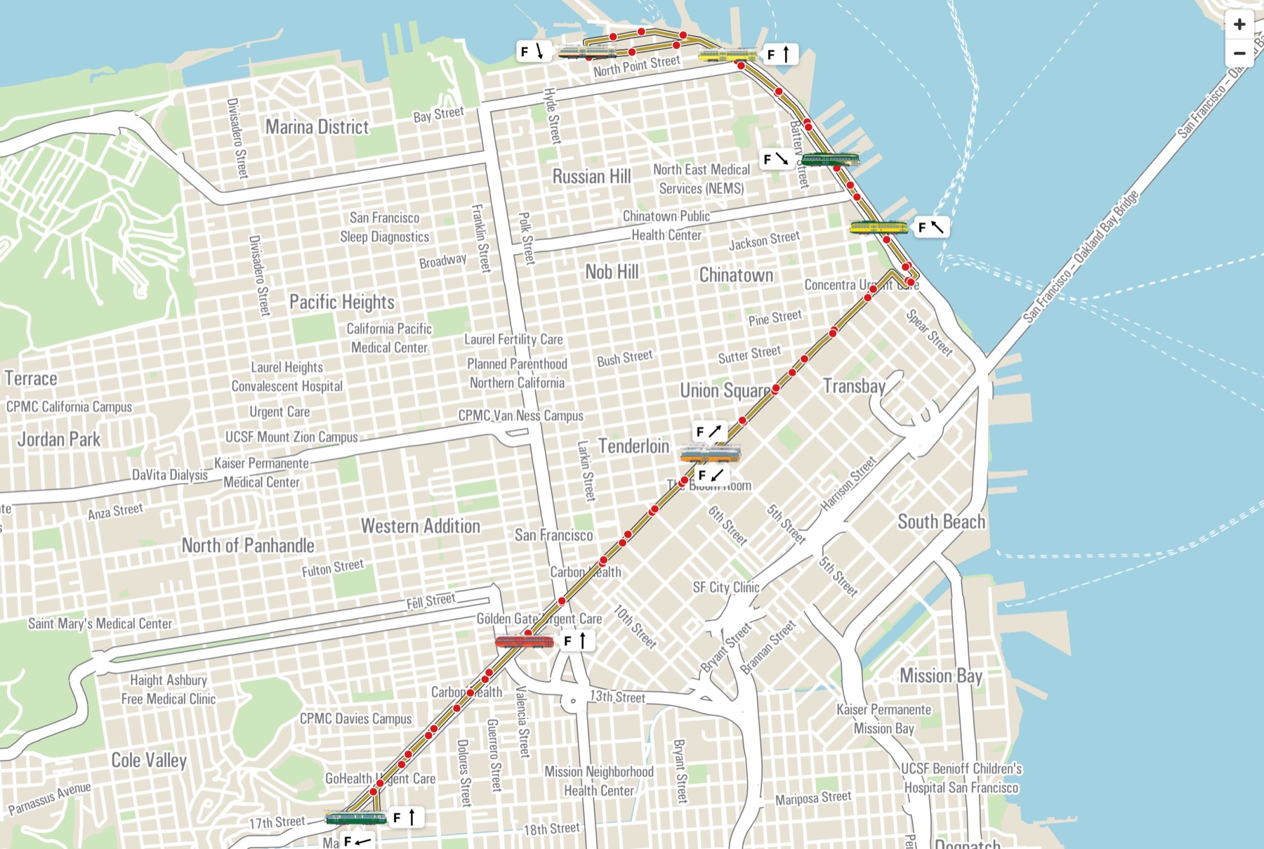 Live map of the F line: streetcars in green, orange, yellow, cream and red liveries, each with a heading arrow, along the route from the Castro to Fisherman's Wharf